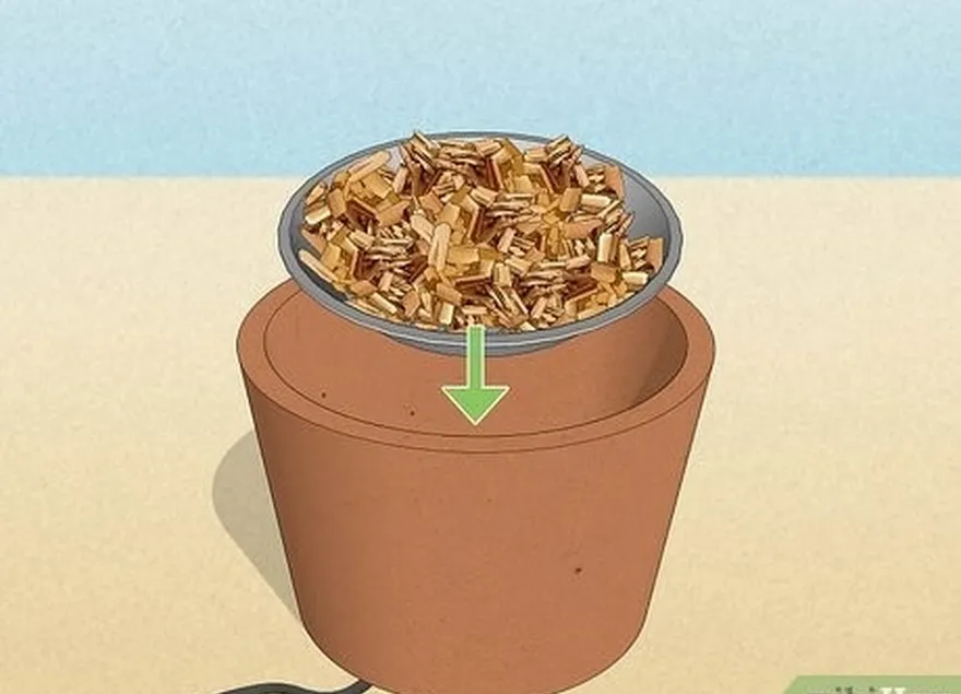 шаг 2 поставьте металлическую сковороду, наполненную влажными древесными стружками, на горячую плиту.