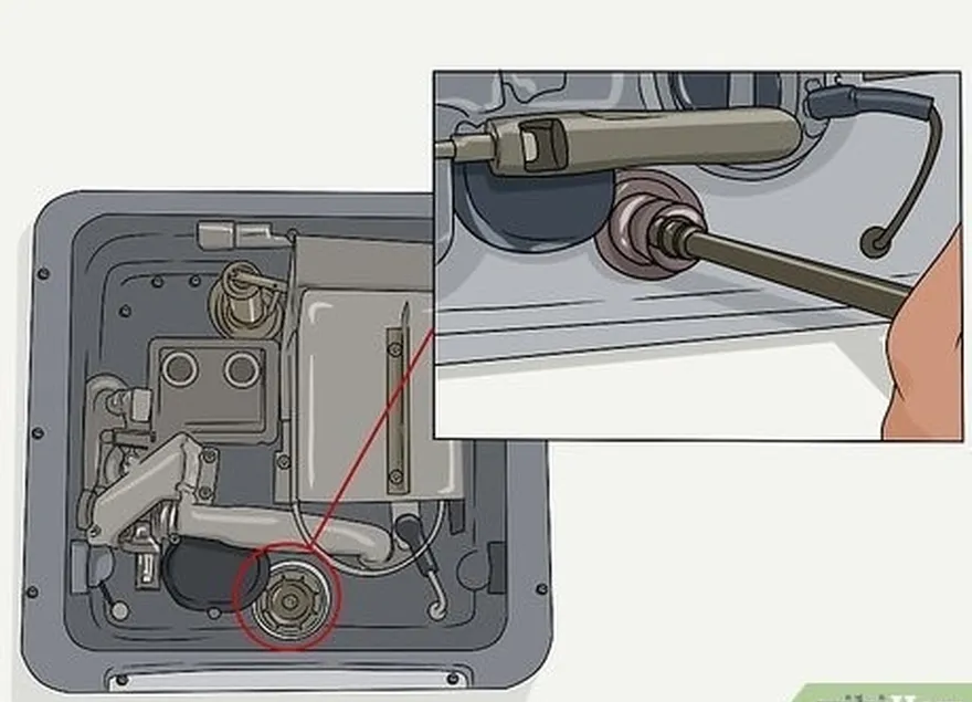 шаг 4 открутите бак's plug or anode rod with a socket wrench.